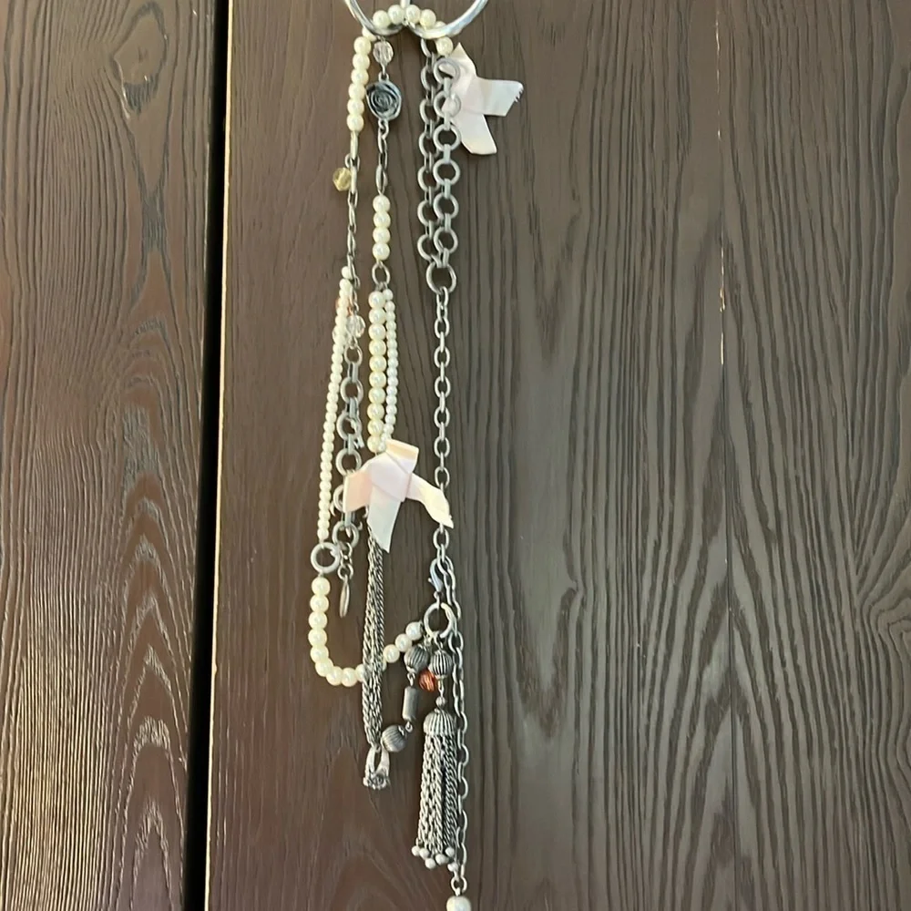 Women’s double chain belt. One of metal objects and the second chain of pearls.